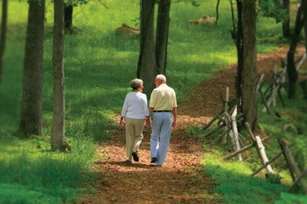 couple walking along wooded trail in Briar Chapel