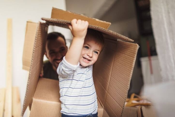 Happy little boy playing with a moving box | Canyon Falls, a new home community in Northlake, Flower Mound and Argyle, TX