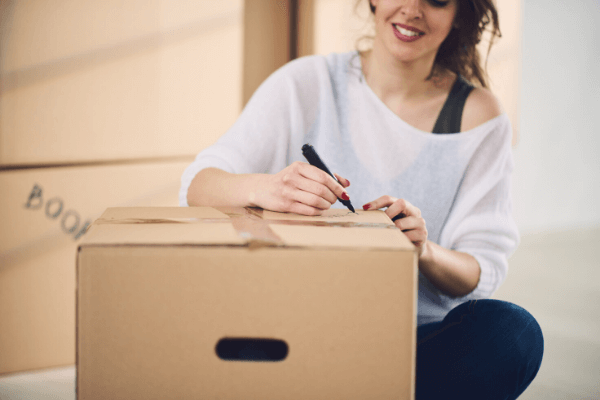 woman labeling a moving box